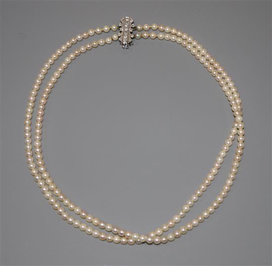 A double strand (ex triple strand) cultured pearl necklace, with 18ct & Pt, diamond set clasp, approx. 38cm.